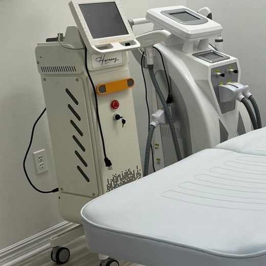 The diode laser, labeled Harmony, beside the treatment bed
